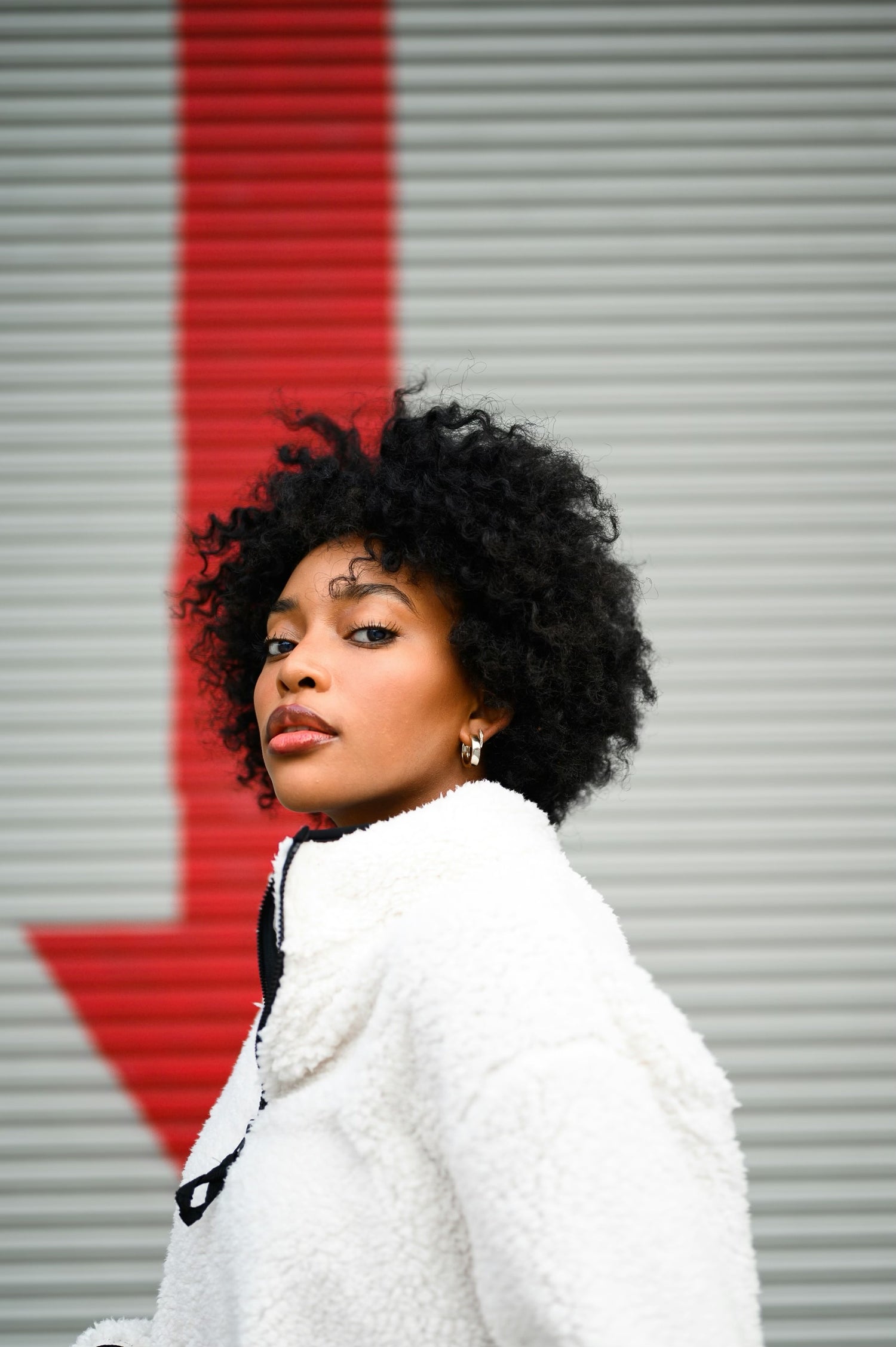 black woman with white fleece on looking at camera