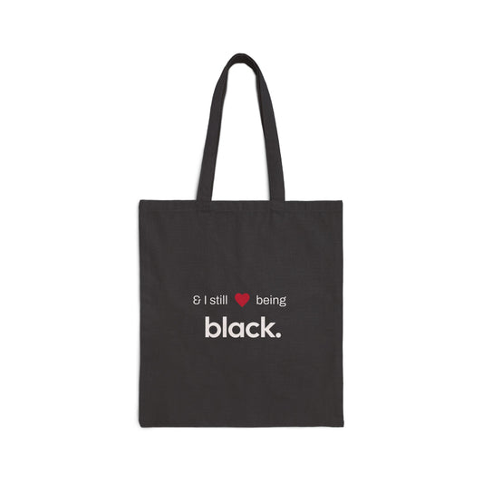 black tote bag with white letters and a red heart