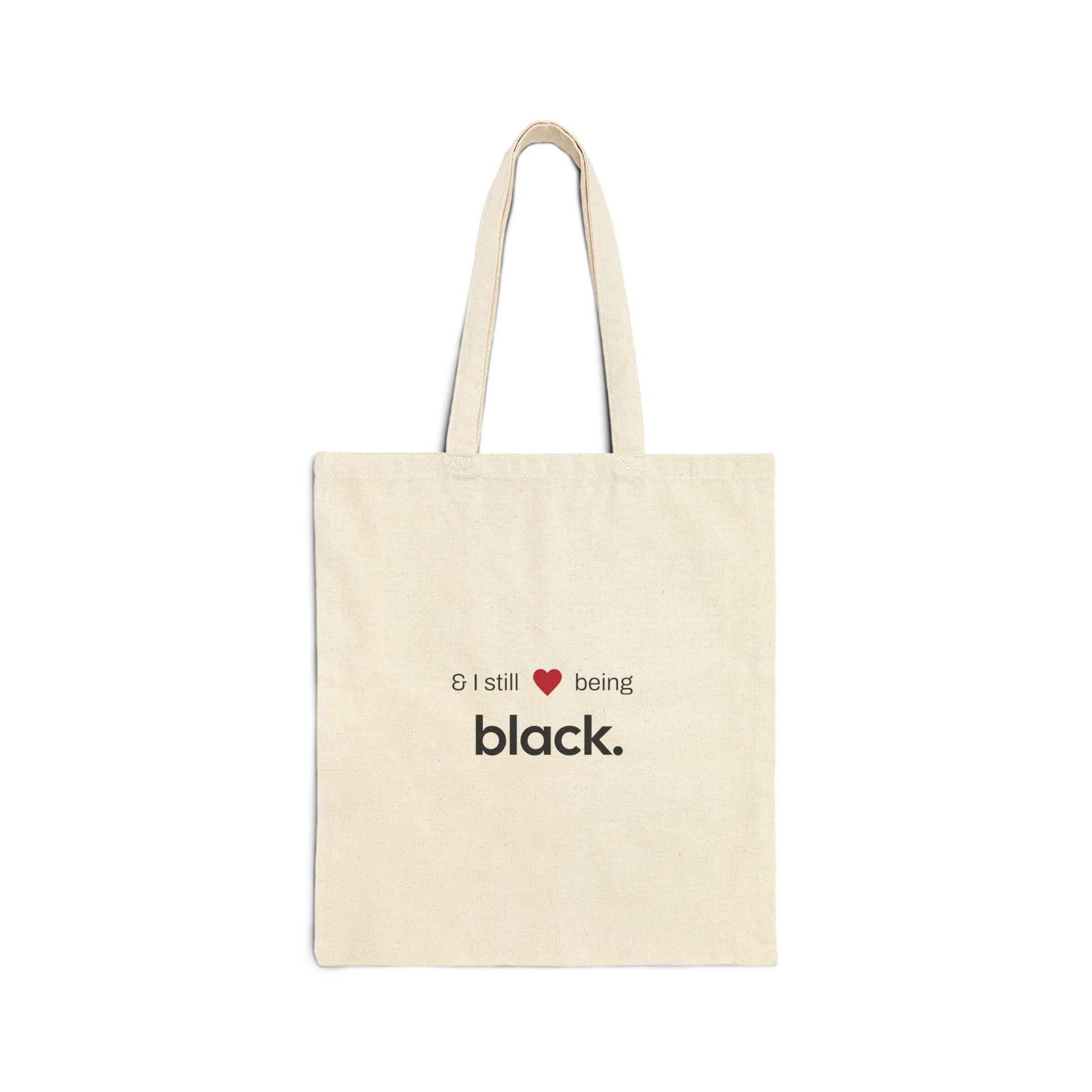 tan tote bag with white letters and a red heart