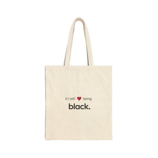 tan tote bag with white letters and a red heart