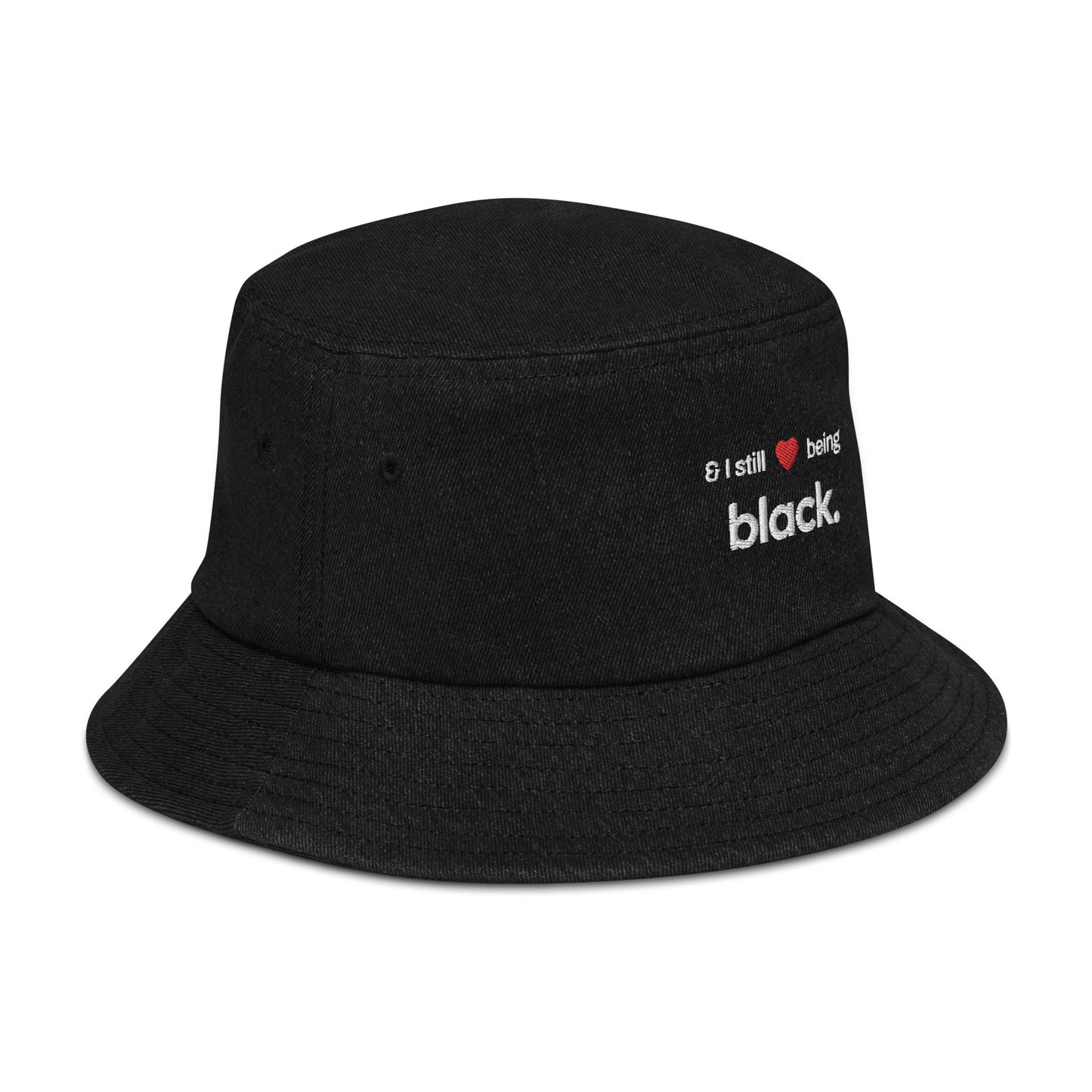 black denim hat side view with red heart and black empowerment phrase on it in white writing.