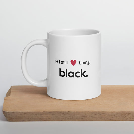 white glossy mug with a black empowerment phrase sitting on a tan cutting board.